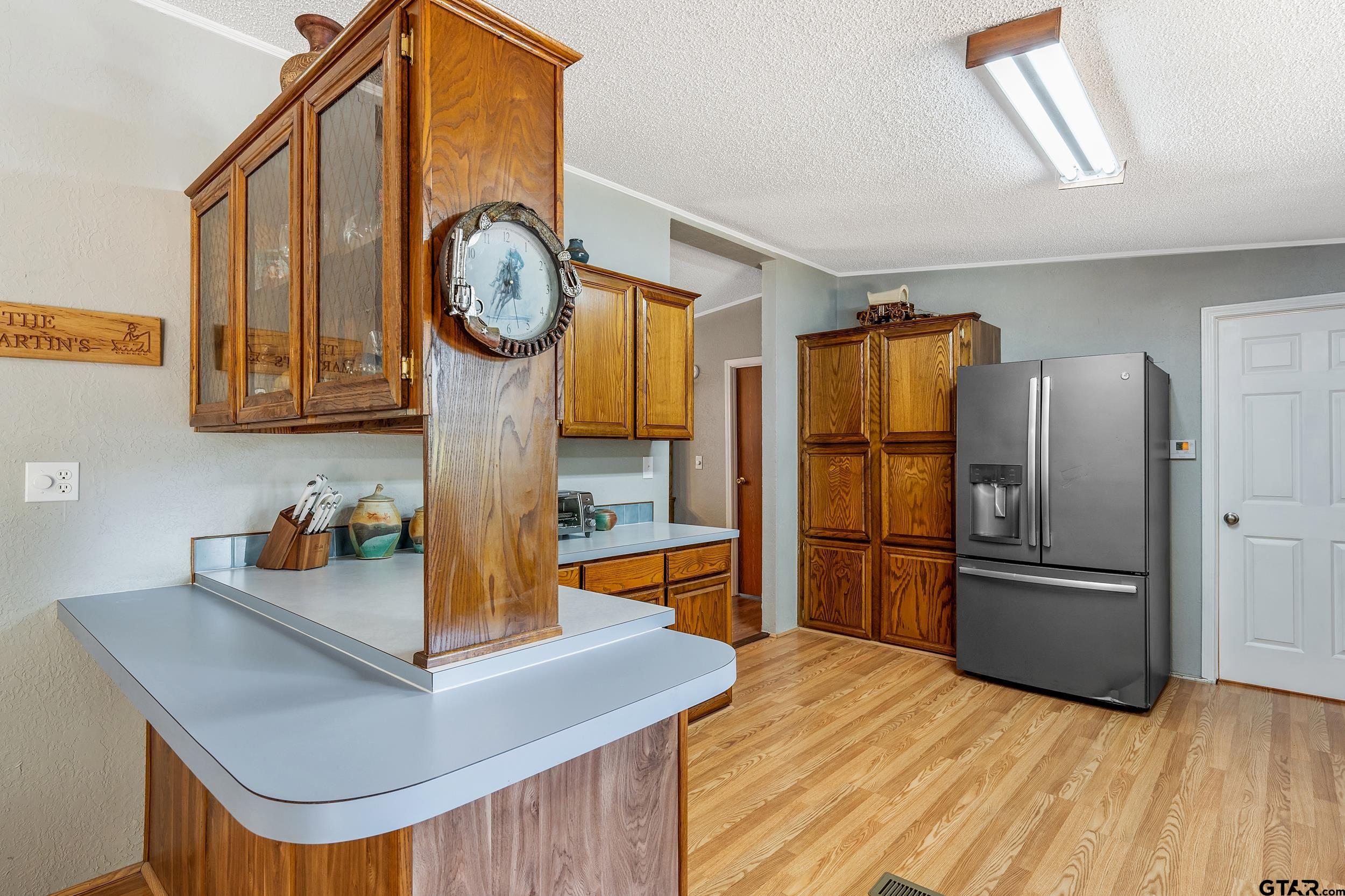 110 Sycamore Lane Murchison, TX 75778 - Photo 12 of 47 a kitchen with stainless steel appliances granite countertop a refrigerator a stove and a sink with dishwasher