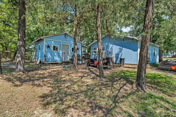 a view of a house with a yard and a patio