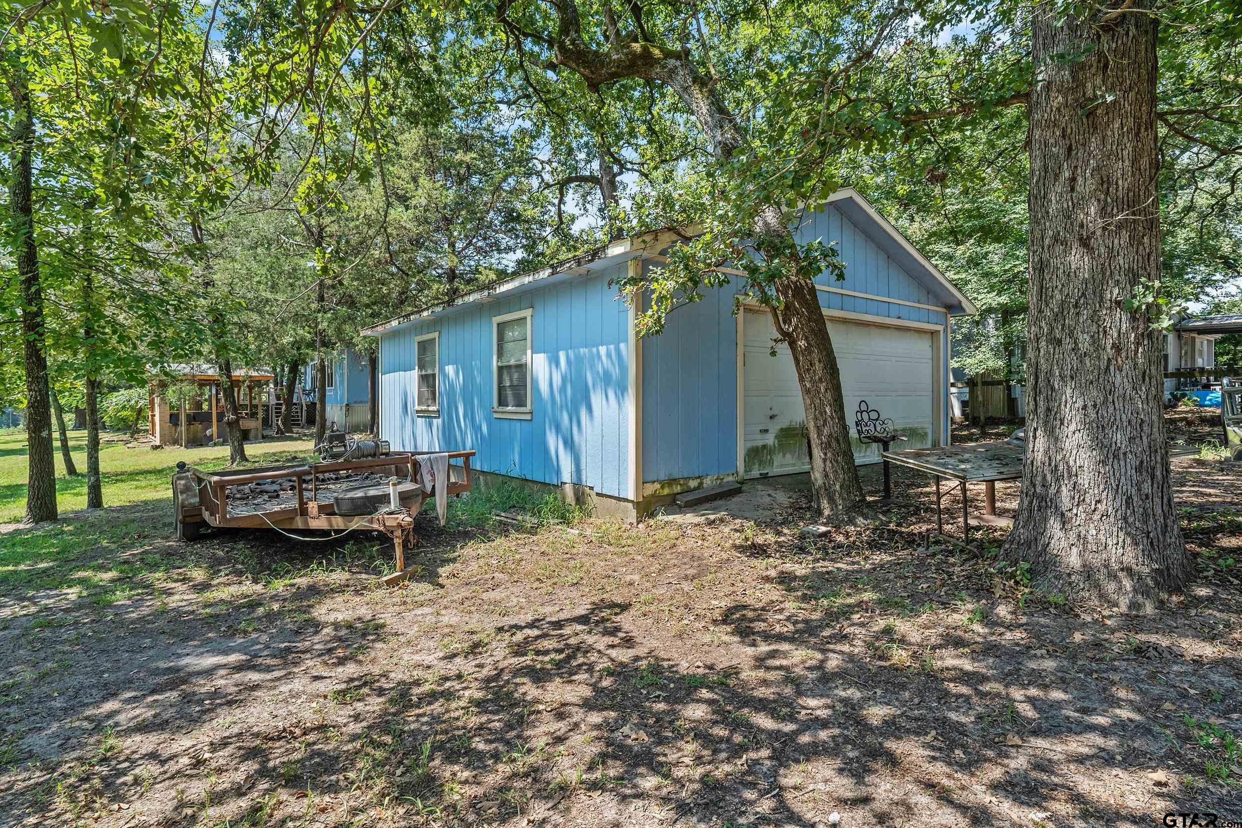110 Sycamore Lane Murchison, TX 75778 - Photo 29 of 47 a backyard of a house with barbeque oven