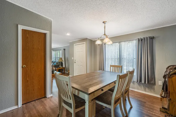 a bedroom with a bed closet and wooden floor