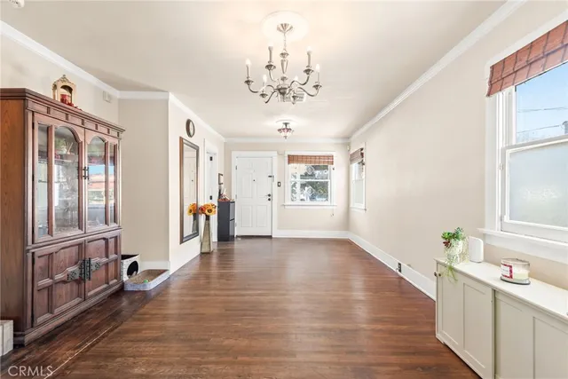 a view of a dining room with furniture and a chandelier
