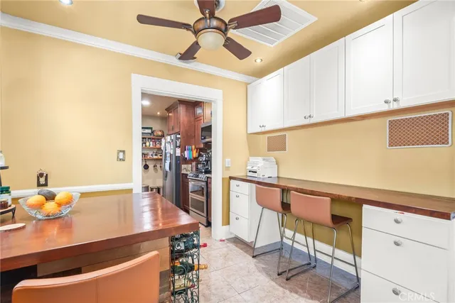 a kitchen that has a lot of cabinets furniture and a chandelier
