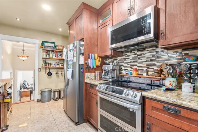 a kitchen with stainless steel appliances granite countertop a sink and cabinets