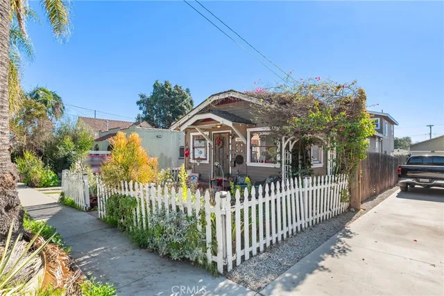 a view of a house with wooden fence