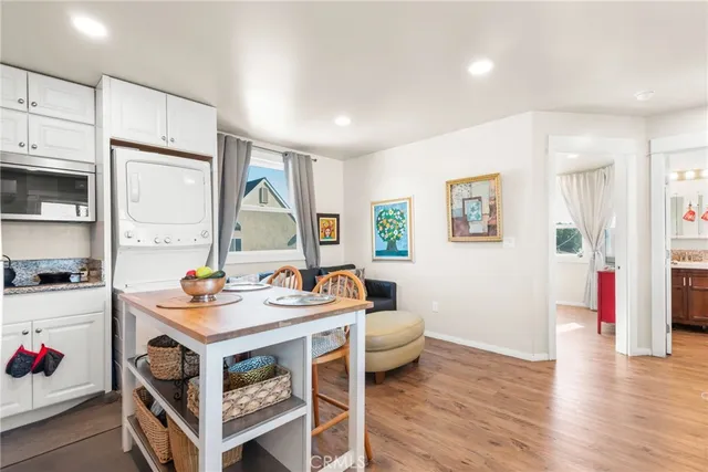 a kitchen with stainless steel appliances granite countertop a sink a stove a refrigerator a center island and cabinets