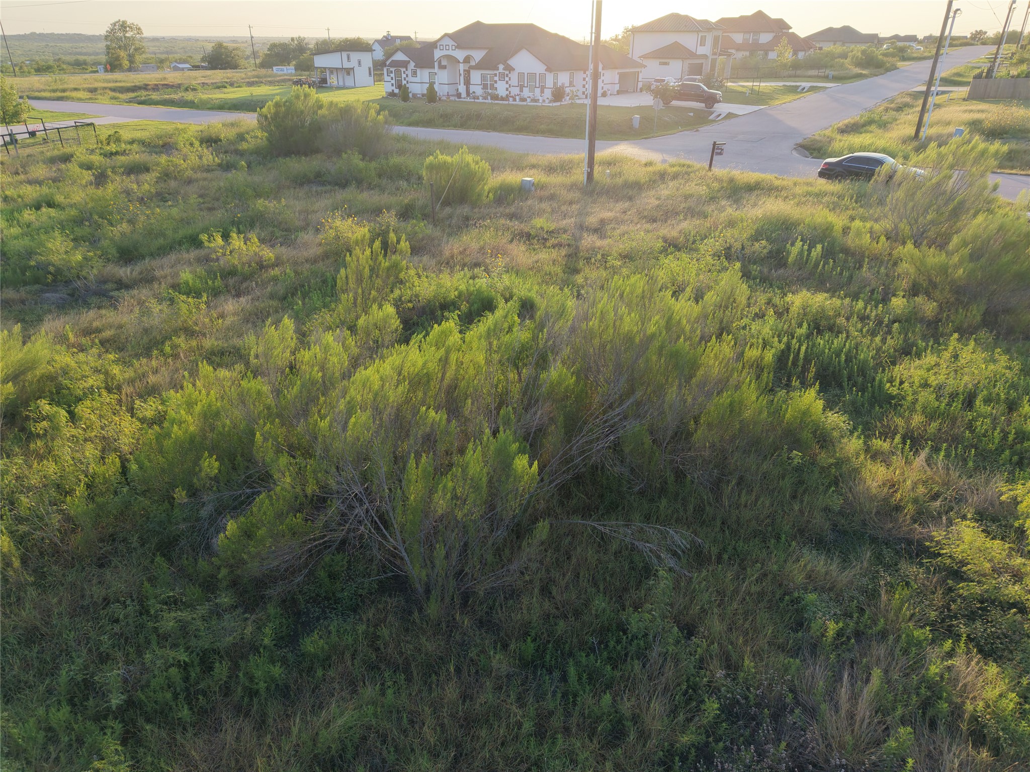 232 East Ridge Lane Kyle, TX 78640 - Photo 6 of 36 A promising undeveloped lot awaits construction in a growing suburban neighborhood.