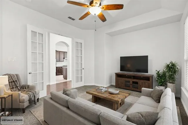 a living room with furniture and a flat screen tv