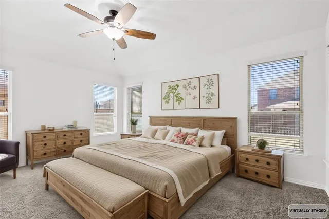 a bedroom with a bed dresser and a window