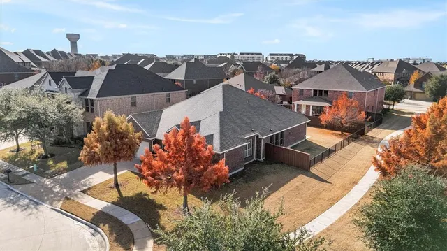 an aerial view of a house with a yard and lake view