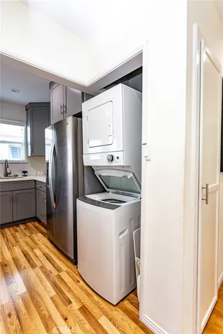 a kitchen with a refrigerator sink and cabinets
