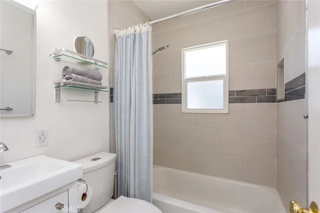 a bathroom with a bathtub sink and toilet