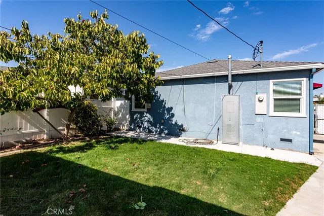 a view of a backyard with plants and a patio