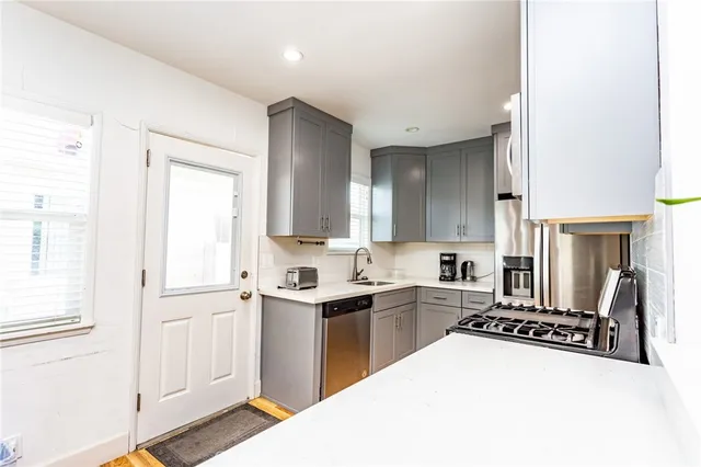 a kitchen with a sink a stove and cabinets