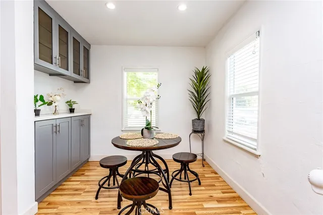 a view of a dining room with furniture and a potted plant