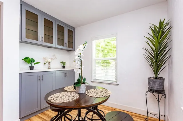 a view of a workspace room with furniture and a potted plant