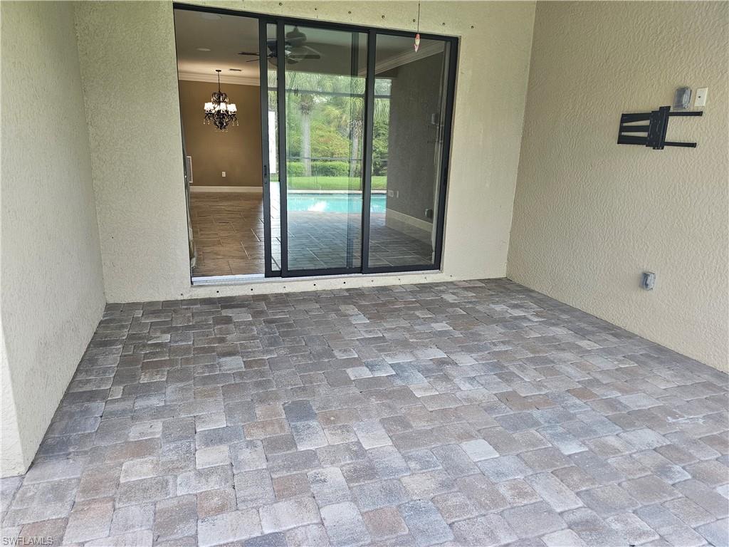 10840 Rutherford Road Fort Myers, FL 33913 - Photo 28 of 35 Bathroom featuring ornamental molding, separate shower and tub, and tile patterned flooring