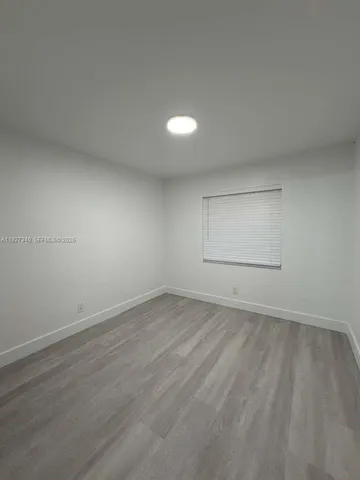 an empty room with a empty space and window