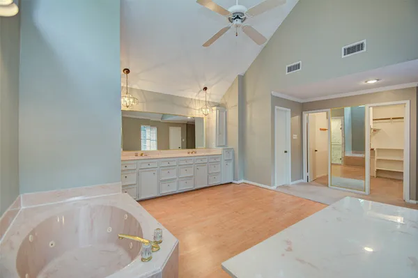a bathroom with a bathtub and mirror