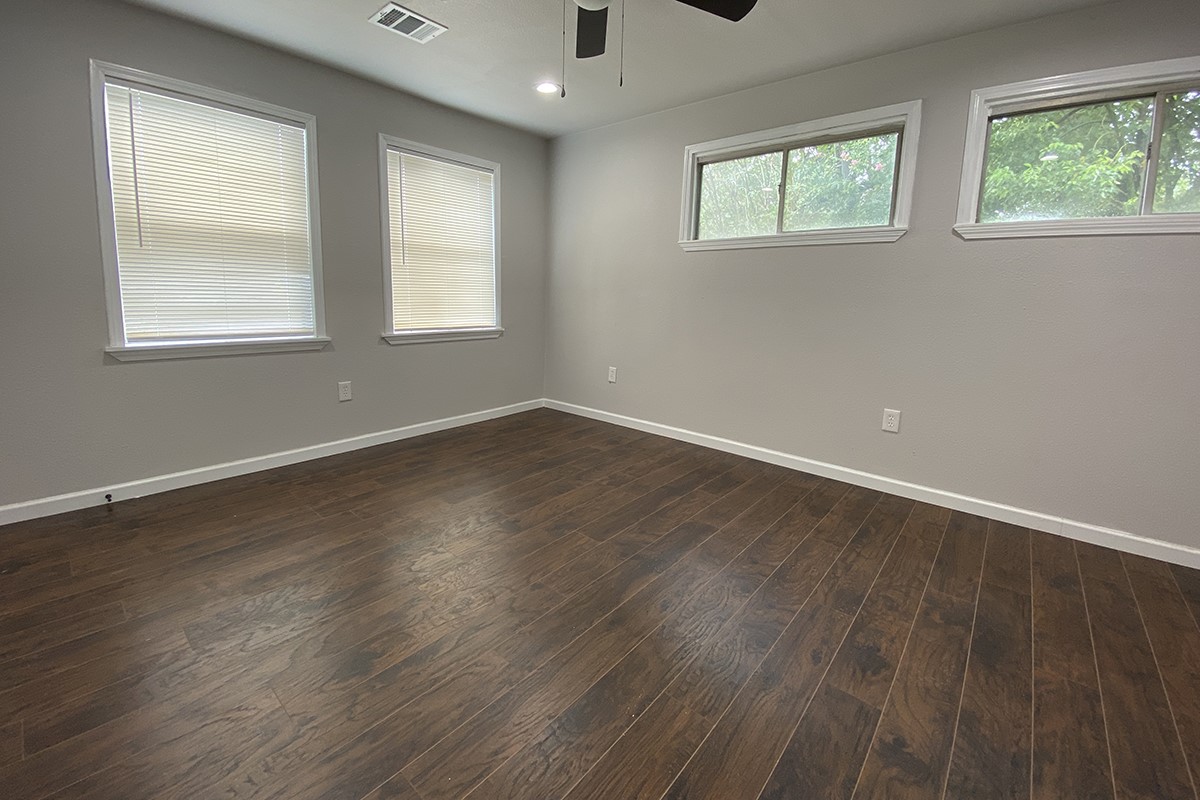 4601 Keystone Street Houston, TX 77021 - Photo 5 of 9 a view of an empty room with wooden floor and a window