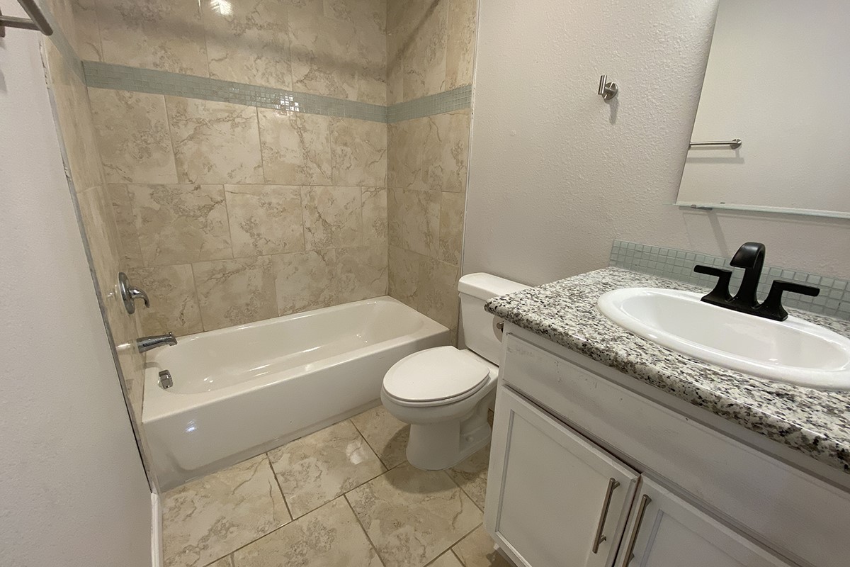 4601 Keystone Street Houston, TX 77021 - Photo 9 of 9 a bathroom with a granite countertop sink toilet and shower
