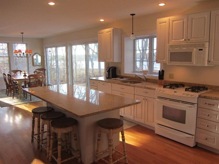 102 Marsh View Road Chatham, MA 02633 - Photo 8 of 23 a kitchen with stainless steel appliances granite countertop a stove a sink and a refrigerator