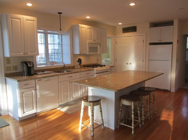 102 Marsh View Road Chatham, MA 02633 - Photo 10 of 23 a kitchen with stainless steel appliances granite countertop a sink a stove and a refrigerator