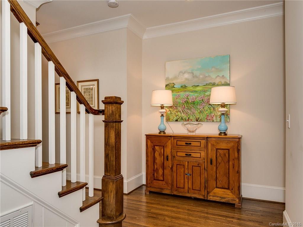 1418 Audubon Road Charlotte, NC 28211 - Photo 2 of 24 a view of a hallway with wooden floor and staircase