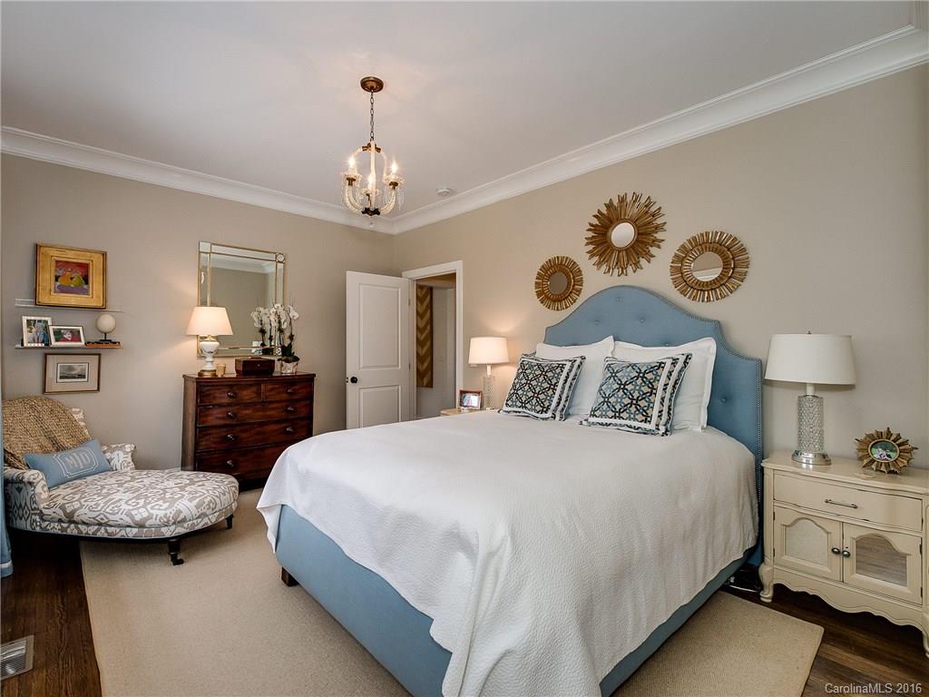 1418 Audubon Road Charlotte, NC 28211 - Photo 11 of 24 a bedroom with a bed and a chandelier