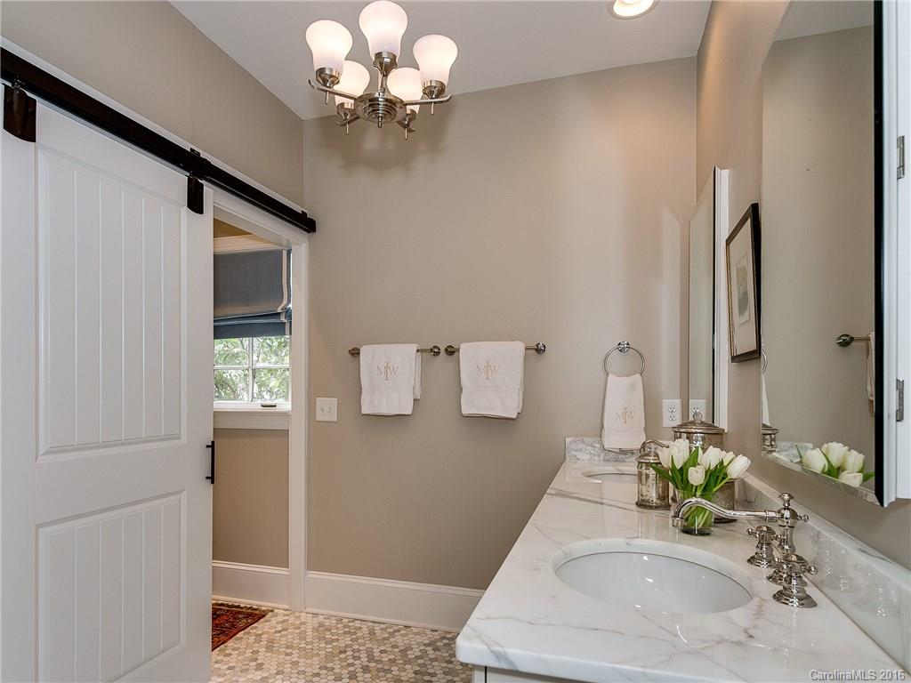 1418 Audubon Road Charlotte, NC 28211 - Photo 12 of 24 a bathroom with a sink a faucet and a mirror
