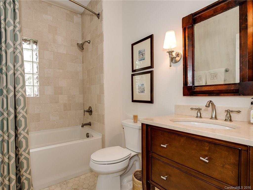 1418 Audubon Road Charlotte, NC 28211 - Photo 15 of 24 a bathroom with a sink a toilet and shower
