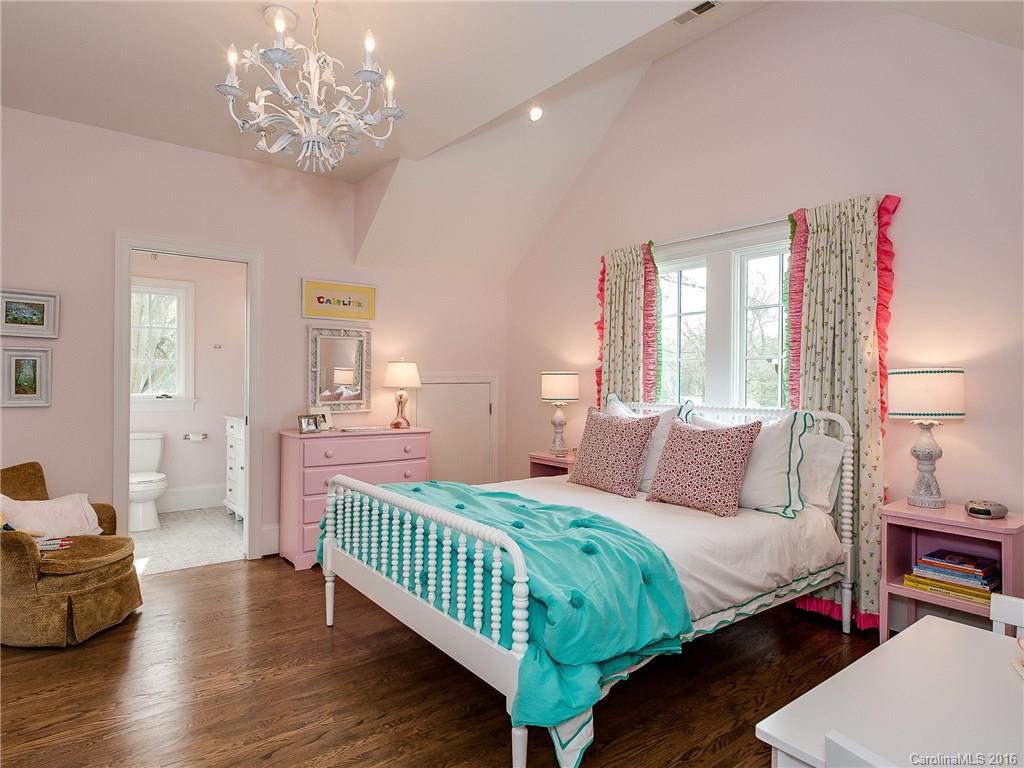 1418 Audubon Road Charlotte, NC 28211 - Photo 19 of 24 a bedroom with a bed and a chandelier