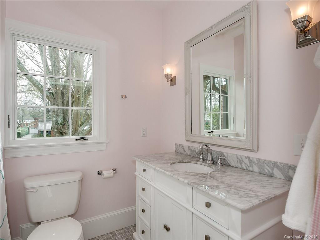 1418 Audubon Road Charlotte, NC 28211 - Photo 20 of 24 a bathroom with a granite countertop toilet a sink and a window