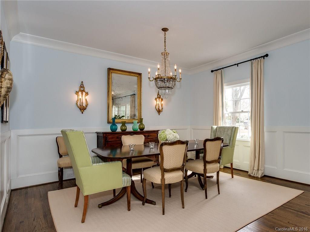 1418 Audubon Road Charlotte, NC 28211 - Photo 5 of 24 a dining room with furniture a chandelier and wooden floor