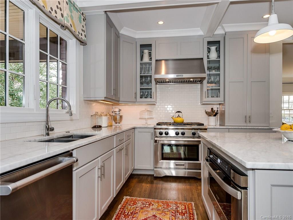 1418 Audubon Road Charlotte, NC 28211 - Photo 6 of 24 a kitchen with a stove sink and microwave
