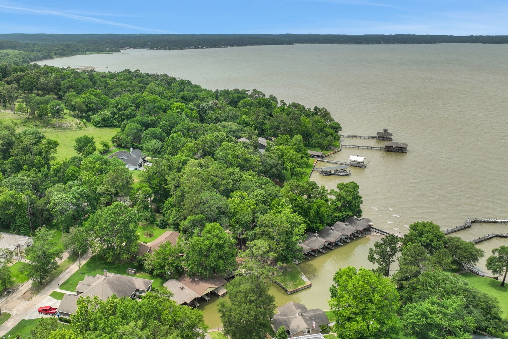 210 Harbor Run Drive Coldspring, TX 77331 - Photo 1 of 43 an aerial view of a houses with a lake view