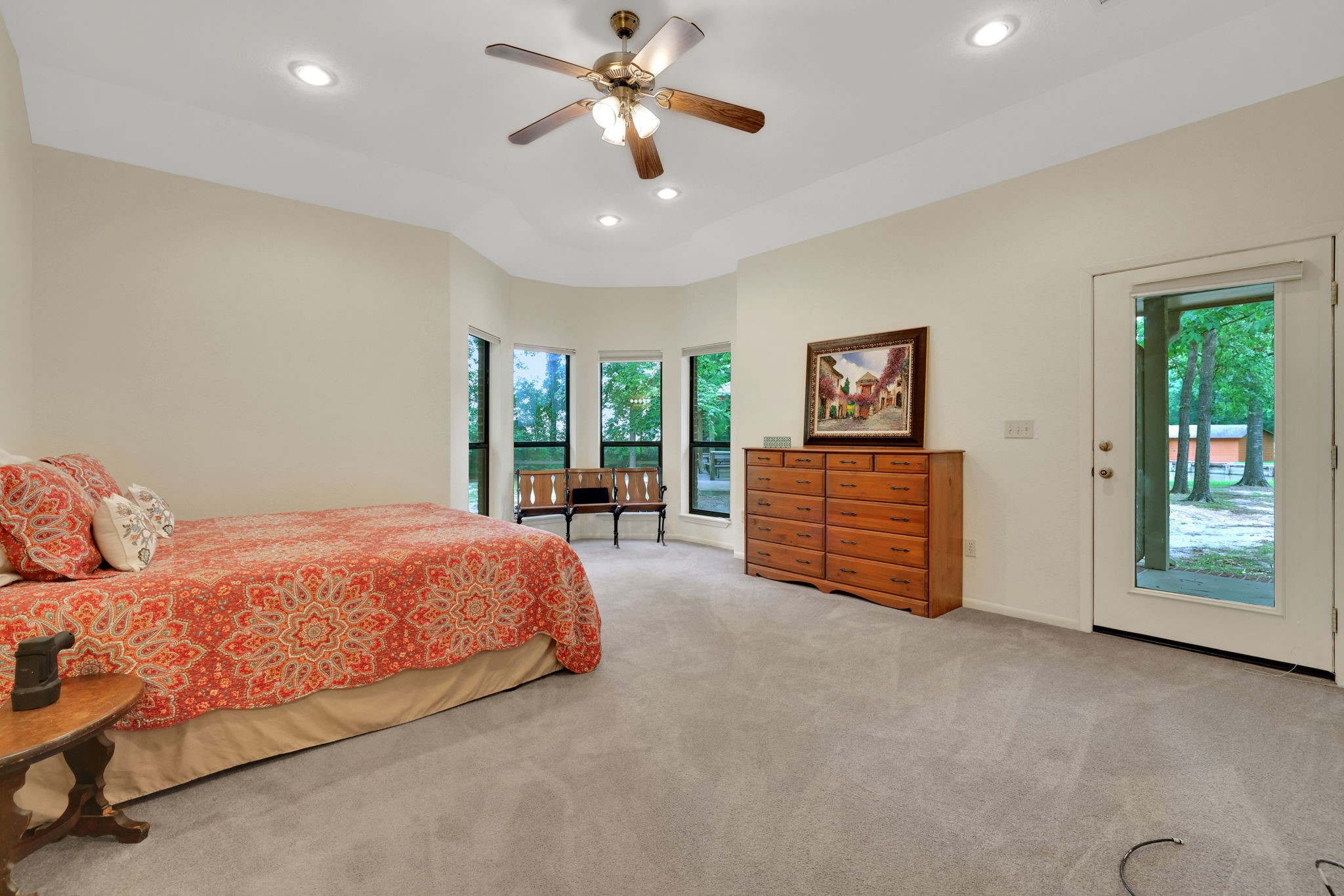 210 Harbor Run Drive Coldspring, TX 77331 - Photo 23 of 43 a spacious bedroom with a bed and a chandelier
