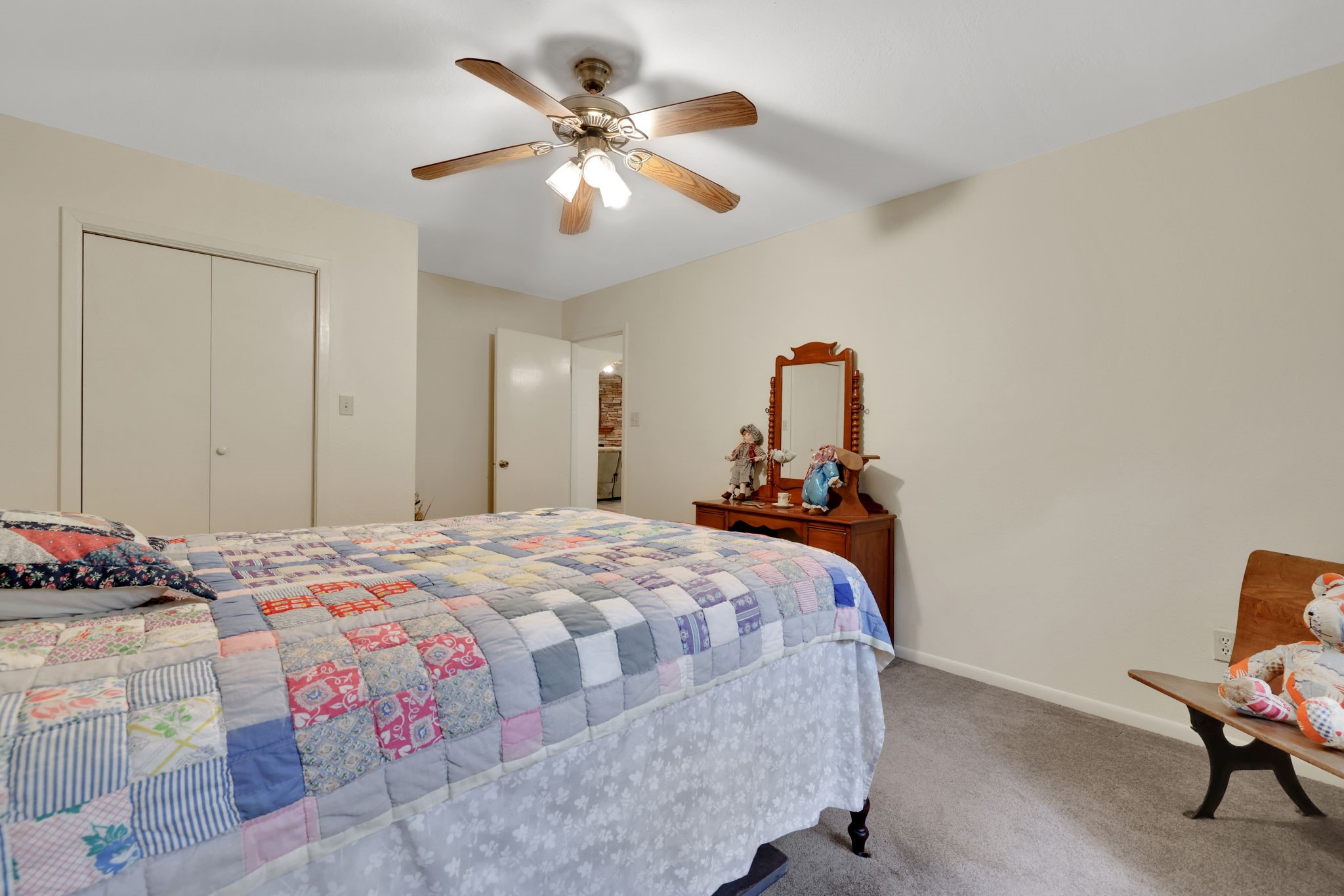 210 Harbor Run Drive Coldspring, TX 77331 - Photo 32 of 43 a bedroom with a bed and a chandelier