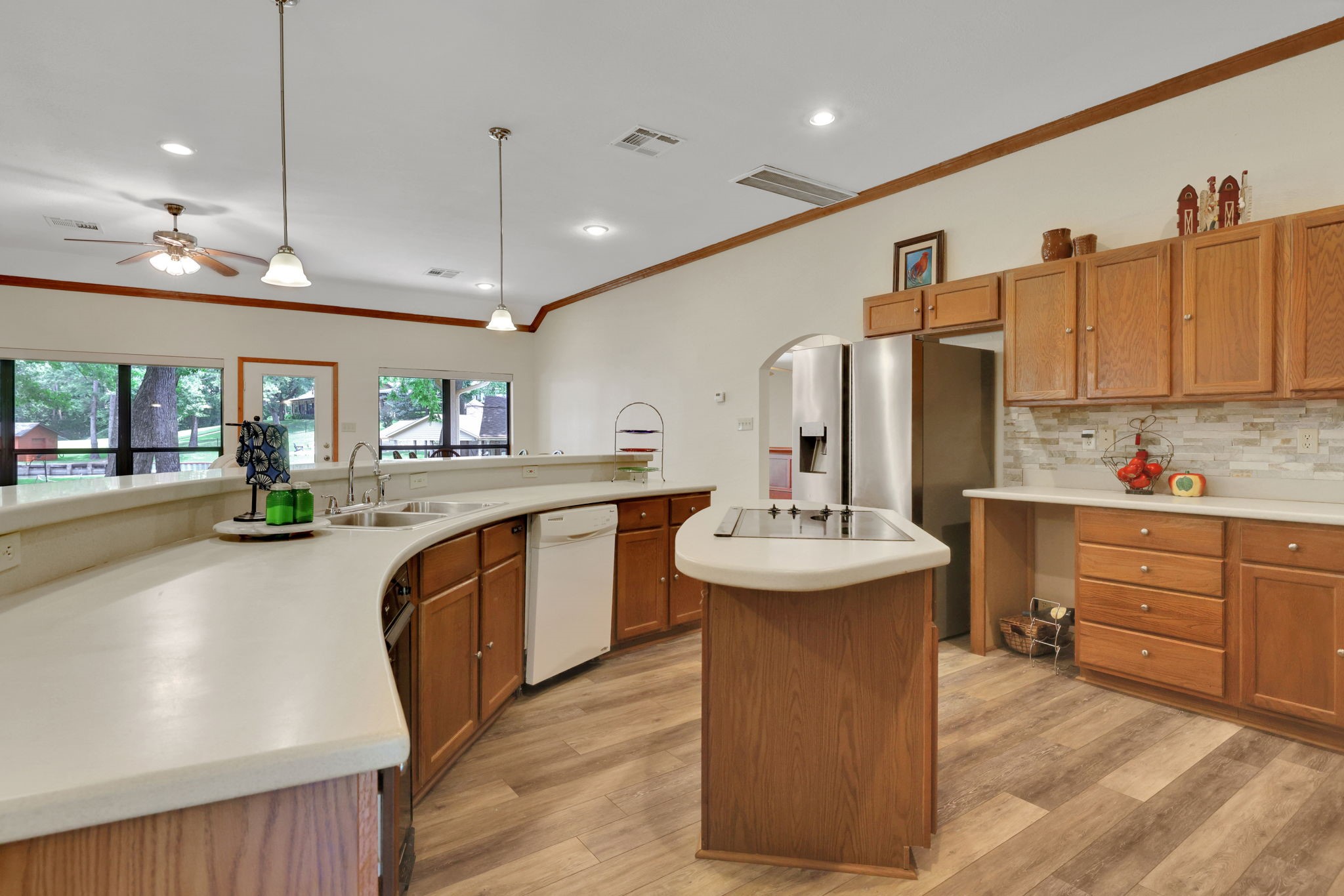 210 Harbor Run Drive Coldspring, TX 77331 - Photo 10 of 43 a large kitchen with kitchen island a sink a counter space and stainless steel appliances