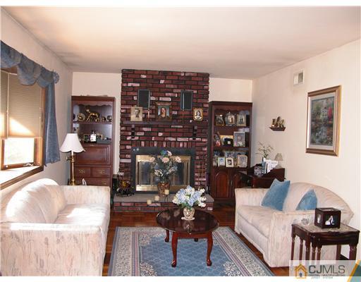 22 Harding Avenue Edison, NJ 08820 - Photo 2 of 14 a living room with furniture a lamp and a potted plant