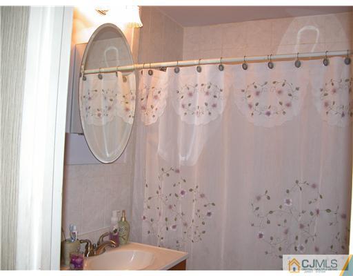 22 Harding Avenue Edison, NJ 08820 - Photo 6 of 14 a bathroom with a shower and a sink