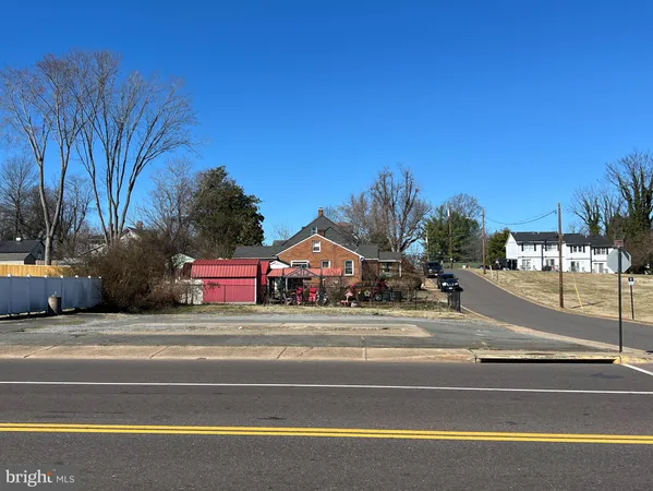a car parked on the side of the road with a house