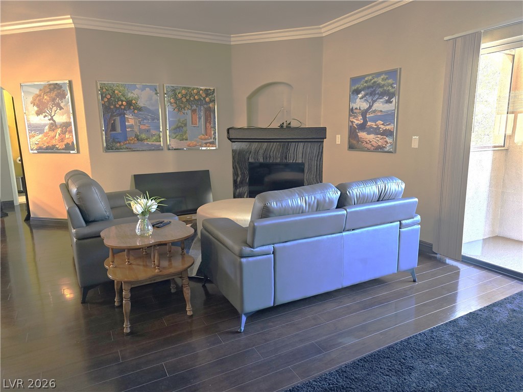 2050 West Warm Springs Road, Unit 2422 Henderson, NV 89014 - Photo 6 of 44 This inviting space features elegant hardwood flooring and a cozy fireplace, perfect for relaxation.