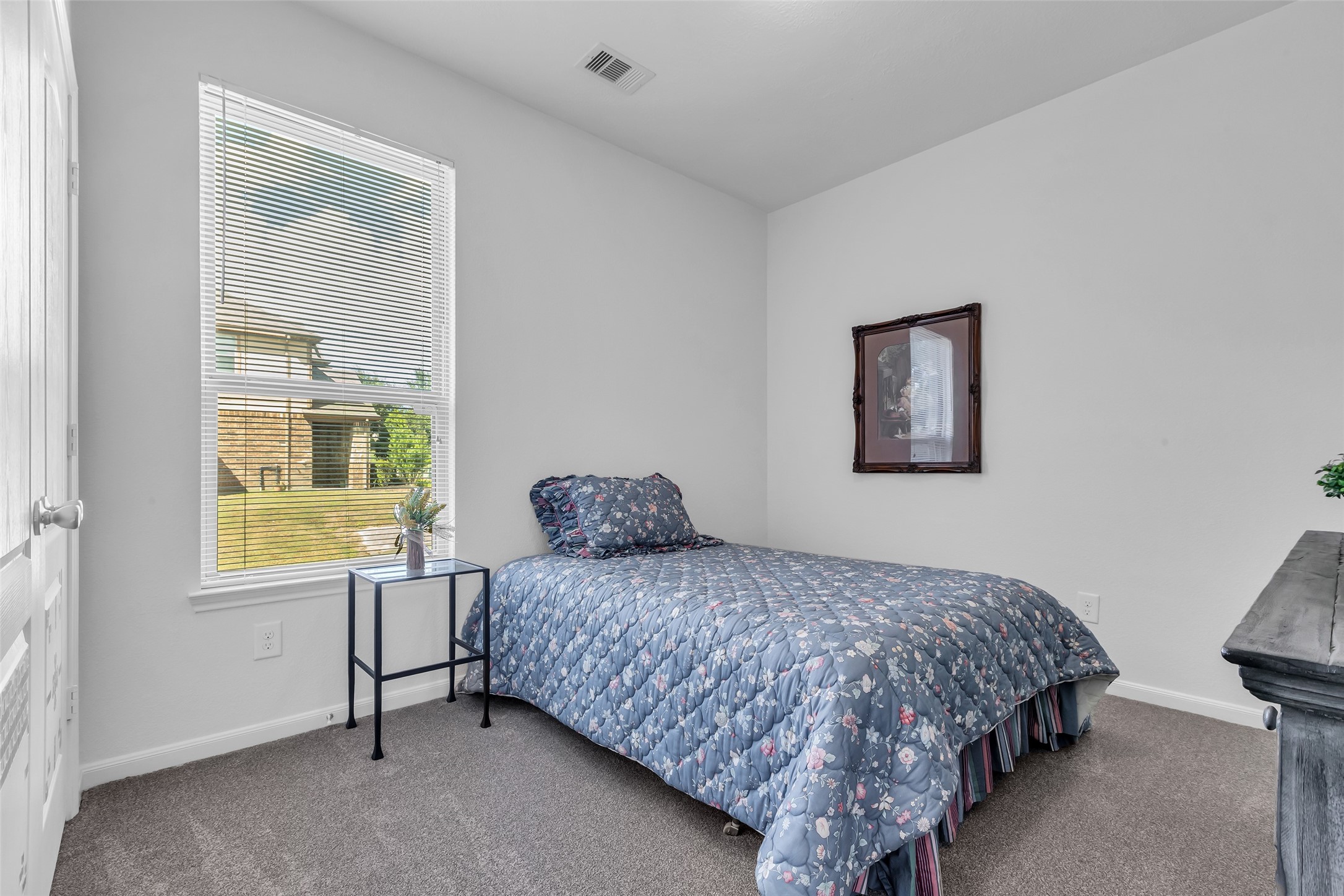 2012 Elkington Circle Conroe, TX 77304 - Photo 29 of 36 a bedroom with a bed lamp and a window