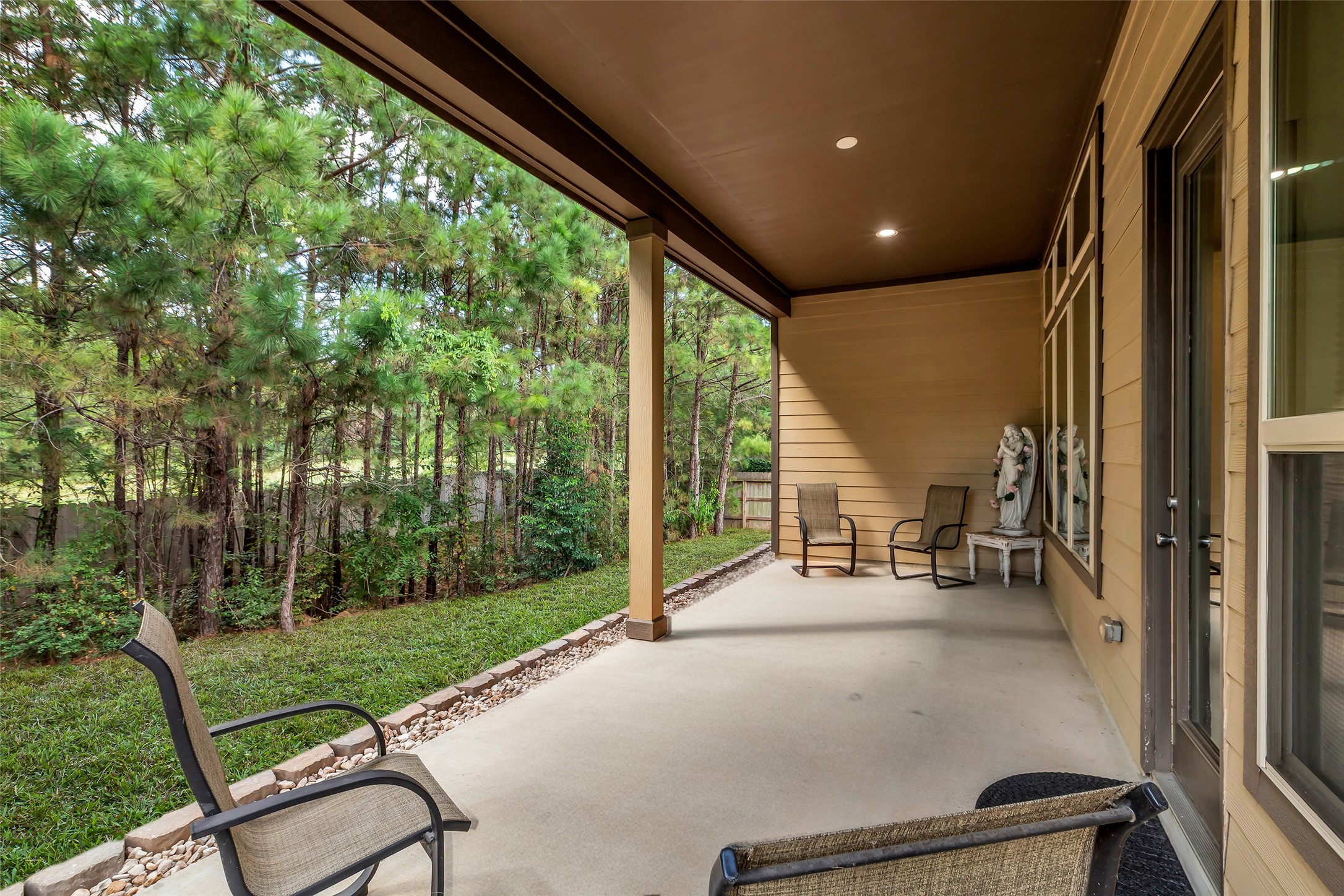 2012 Elkington Circle Conroe, TX 77304 - Photo 30 of 36 a view of a porch with chairs and backyard