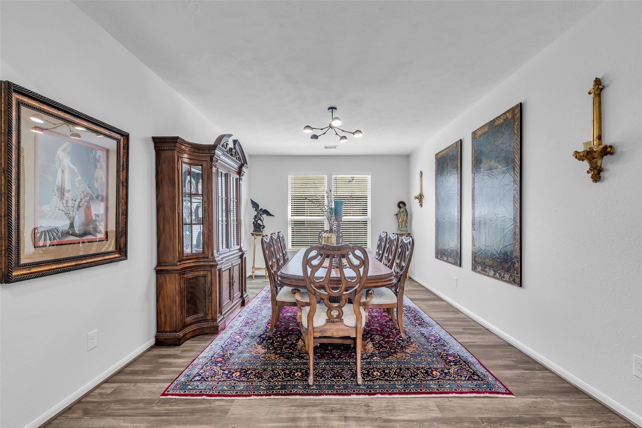2012 Elkington Circle Conroe, TX 77304 - Photo 7 of 36 a dining room with wooden floor and a rug
