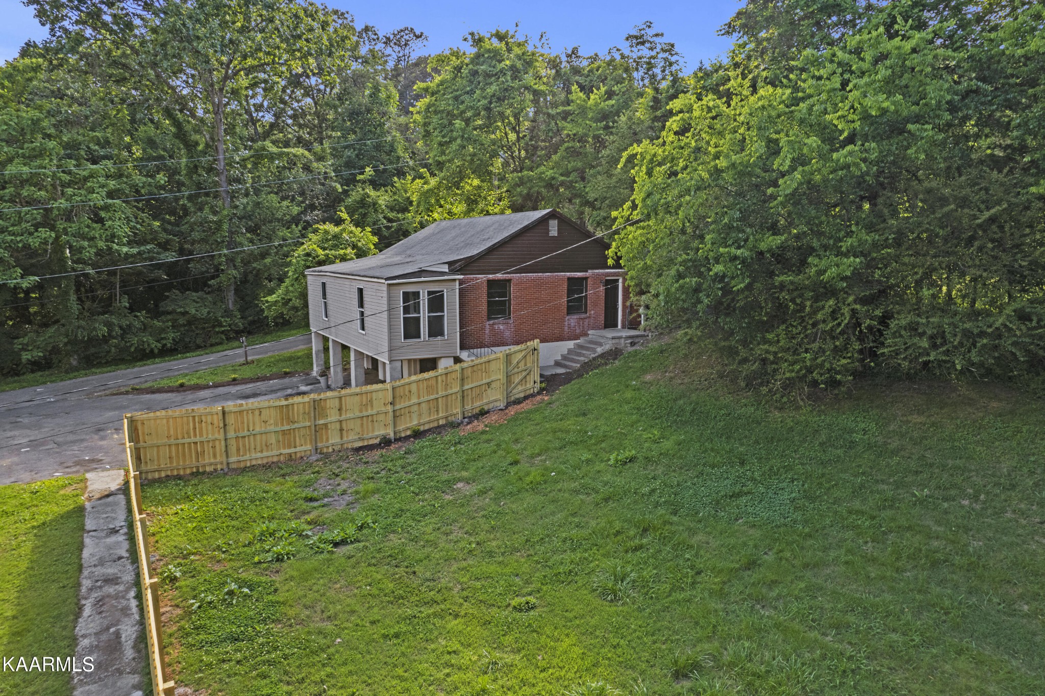 313 Potter Road Clinton, TN 37716 - Photo 16 of 24 a view of house with a yard