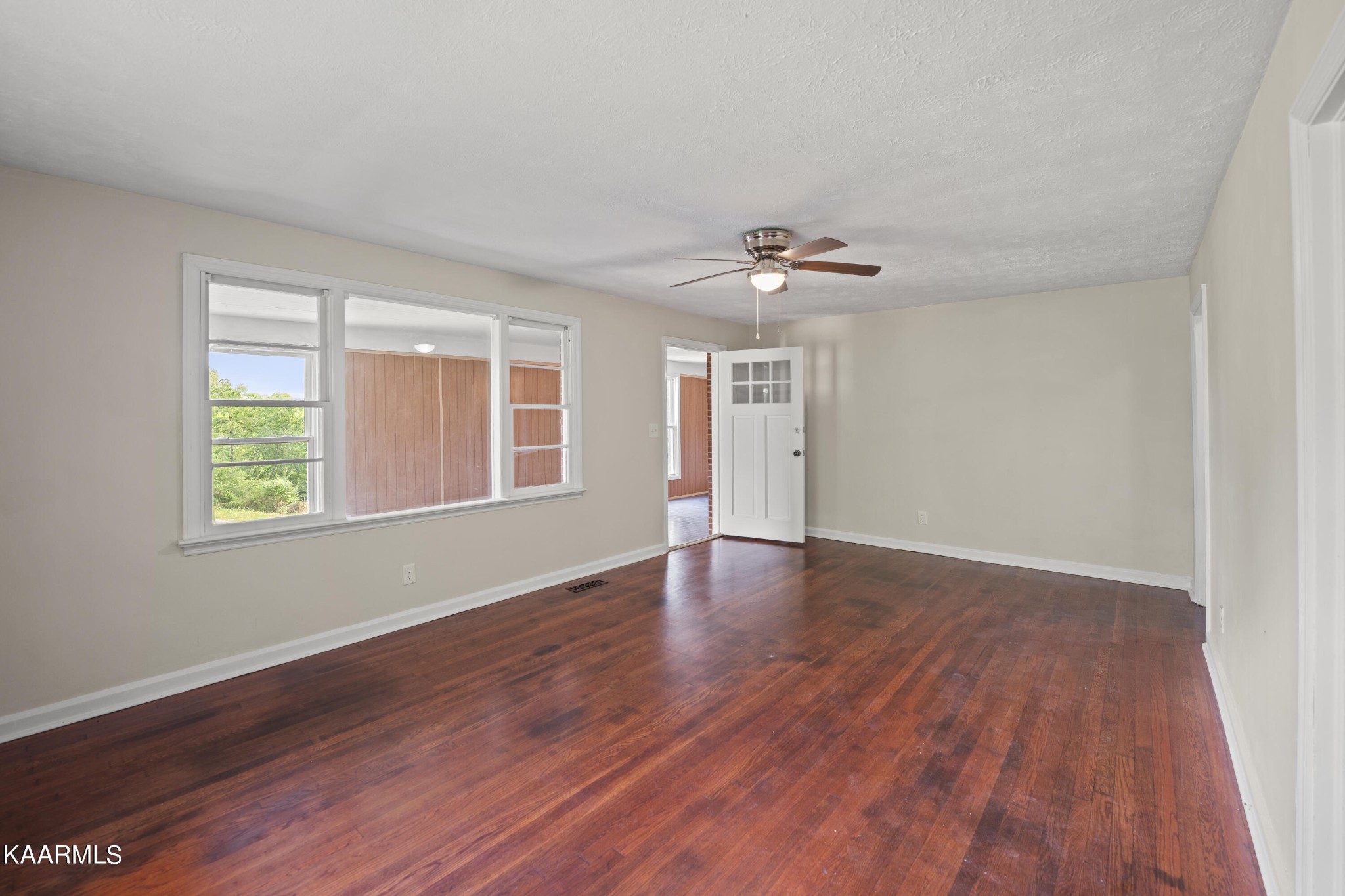 313 Potter Road Clinton, TN 37716 - Photo 3 of 24 a view of an empty room with wooden floor and a window