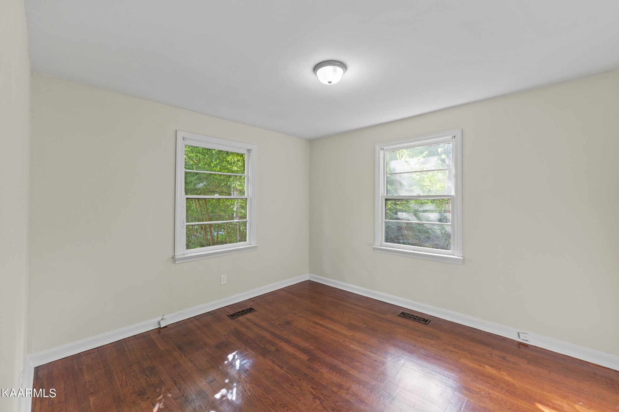313 Potter Road Clinton, TN 37716 - Photo 8 of 24 an empty room with wooden floor and windows