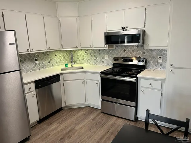 a kitchen with a stove and a microwave