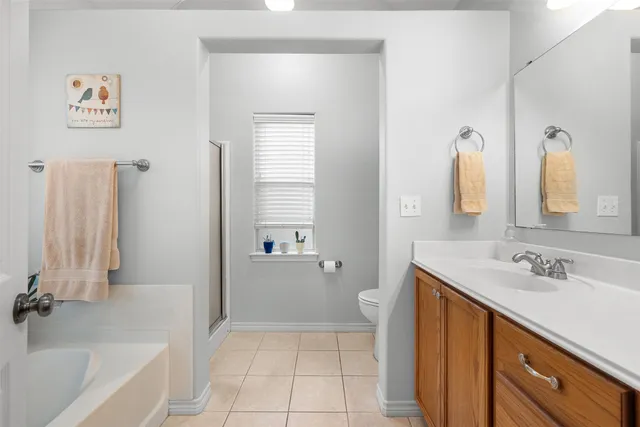 a bathroom with a tub a sink and a mirror